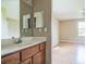 This bathroom features a vanity with light countertops and dual mirrors, plus access to the main bedroom at 2503 Se 18Th Cir, Ocala, FL 34471