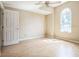 Bedroom featuring an arched window and light-colored walls plus a ceiling fan at 2503 Se 18Th Cir, Ocala, FL 34471