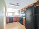 Kitchen features black appliances, and wood-look flooring at 2503 Se 18Th Cir, Ocala, FL 34471