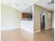 Cozy living room area with wood floors opens to kitchen with wood cabinets at 2503 Se 18Th Cir, Ocala, FL 34471