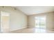 Spacious living room with sliding glass doors leading to the exterior and a connecting door at 2503 Se 18Th Cir, Ocala, FL 34471
