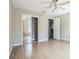 Spacious main bedroom featuring sliding closet doors, wood laminate floors, and neutral walls at 2503 Se 18Th Cir, Ocala, FL 34471