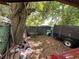 Leafy backyard with a large tree, trailer, and fence at 2520 Raehn St, Orlando, FL 32806