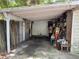 Carport with storage and overgrown foliage needs clearing at 2520 Raehn St, Orlando, FL 32806