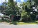 Overgrown property with lush, mature trees and vegetation offers privacy and a natural setting at 2520 Raehn St, Orlando, FL 32806