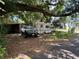 Outside view of a house next to an RV and a car parked under a large tree providing shade at 2520 Raehn St, Orlando, FL 32806