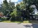 Overgrown property with lush, mature trees and vegetation offers privacy and a natural setting at 2520 Raehn St, Orlando, FL 32806