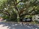 Street view of property with mature tree providing shade and covering two cars and an RV at 2520 Raehn St, Orlando, FL 32806
