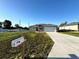 Charming single-story home features a well-manicured lawn, long driveway, and a neutral exterior paint scheme at 2730 Sw 144Th Pl, Ocala, FL 34473