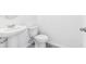 Half bathroom featuring a pedestal sink, toilet, and gray tile floors at 2774 Virginia Pine Dr, Bartow, FL 33830