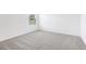 A naturally lit bedroom featuring neutral carpet and a window view at 2774 Virginia Pine Dr, Bartow, FL 33830