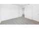 A standard bedroom with neutral carpet, white walls, and a view into another room at 2774 Virginia Pine Dr, Bartow, FL 33830