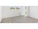 Bright bedroom features neutral carpet, base trim, two windows, and a closet door at 2774 Virginia Pine Dr, Bartow, FL 33830
