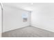 A bright bedroom showcasing neutral carpet and a large window with blinds at 2774 Virginia Pine Dr, Bartow, FL 33830