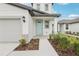 Charming home featuring a blue door, two-car garage, manicured landscaping and a welcoming entrance at 2774 Virginia Pine Dr, Bartow, FL 33830
