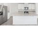 Modern kitchen with granite countertops, stainless steel appliances, large island, and tile flooring at 2774 Virginia Pine Dr, Bartow, FL 33830