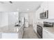 Bright kitchen features stainless appliances, granite countertops, white cabinets, and tile flooring at 2774 Virginia Pine Dr, Bartow, FL 33830