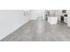 Open concept living space featuring gray tile floors and a kitchen with stainless steel appliances and a center island at 2774 Virginia Pine Dr, Bartow, FL 33830