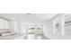 Open-concept living space with tile floors, stainless steel kitchen appliances, and sliding glass doors to backyard at 2774 Virginia Pine Dr, Bartow, FL 33830