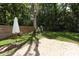 Lush backyard featuring a brick patio, well-maintained lawn, mature trees, and a wooden privacy fence at 304 Little Springs Ln, Longwood, FL 32750