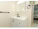 Bathroom featuring a white vanity, a large mirror, and modern fixtures near the bedroom entrance at 304 Little Springs Ln, Longwood, FL 32750