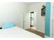 Cozy bedroom with wood floors and a door leading to the kitchen at 304 Little Springs Ln, Longwood, FL 32750