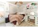 Stylish bedroom with a tapestry, whitewashed wood accent wall, and a desk area at 304 Little Springs Ln, Longwood, FL 32750