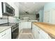 Bright, white kitchen with granite counters and stainless steel appliances at 304 Little Springs Ln, Longwood, FL 32750