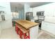 Charming kitchen features a wooden table island and white cabinets at 304 Little Springs Ln, Longwood, FL 32750