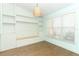 Bright living area with custom built-ins, wood floors and an accent light fixture at 304 Little Springs Ln, Longwood, FL 32750