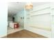 Open-concept area with breakfast bar, custom built-ins, and wood floors at 304 Little Springs Ln, Longwood, FL 32750