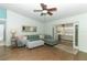 Open living room with wood floors, ceiling fan, and access to the sunroom at 304 Little Springs Ln, Longwood, FL 32750