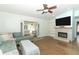 Comfortable living room with a fireplace, wood floors, and open doorways at 304 Little Springs Ln, Longwood, FL 32750