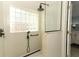 Modern shower with glass block window, hand shower, and glass partition near the bedroom at 304 Little Springs Ln, Longwood, FL 32750