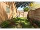 Side yard featuring a green lawn, raised garden beds, wooden fencing, and blooming flowering trees at 304 Little Springs Ln, Longwood, FL 32750