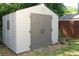 Spacious outdoor storage shed in backyard, featuring large double doors and durable siding at 304 Little Springs Ln, Longwood, FL 32750