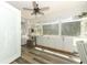 Bright sunroom with lots of light, featuring lots of windows, built-in storage, and modern ceiling fan at 304 Little Springs Ln, Longwood, FL 32750
