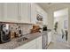 The bar area features white cabinets, a marble backsplash, granite countertops, and a beverage cooler at 3259 Buoy Cir, Winter Garden, FL 34787