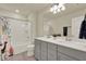 Bright bathroom features a double sink vanity, a shower-tub combo, and neutral tones for a clean and modern aesthetic at 3259 Buoy Cir, Winter Garden, FL 34787