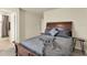 Cozy bedroom with wooden bed frame, grey patterned bedding, and views towards the bathroom at 3259 Buoy Cir, Winter Garden, FL 34787