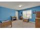 Bedroom with blue walls, a window with blinds, and wooden furnishings at 3259 Buoy Cir, Winter Garden, FL 34787