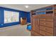 Bright bedroom with blue walls, a wooden dresser with toys and a trundle bed provide ample space for  at 3259 Buoy Cir, Winter Garden, FL 34787