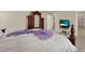 Spacious bedroom features an antique wardrobe and a comfortable bed with a cozy purple throw blanket at 3259 Buoy Cir, Winter Garden, FL 34787