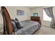 Comfortable bedroom with a wooden bed frame, grey patterned bedding, and a window with decorative curtains at 3259 Buoy Cir, Winter Garden, FL 34787
