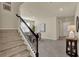 Open entryway with a staircase, decorative table, and view into the adjacent dining room at 3259 Buoy Cir, Winter Garden, FL 34787