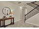 Elegant entryway with tiled floors, decorative table, and staircase with wrought iron railing at 3259 Buoy Cir, Winter Garden, FL 34787