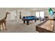 Spacious game room with a pool table, shuffleboard, and comfortable seating area creates an inviting entertainment space at 3259 Buoy Cir, Winter Garden, FL 34787