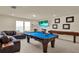 Entertaining game room with pool table, shuffleboard, and cozy seating, perfect for fun gatherings at 3259 Buoy Cir, Winter Garden, FL 34787