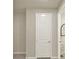 A hallway shows a white paneled door and trim, with neutral-painted walls and gray tile flooring at 3259 Buoy Cir, Winter Garden, FL 34787