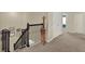 Upper hallway with black iron railing provides a clear path and nice transition between spaces on the top floor at 3259 Buoy Cir, Winter Garden, FL 34787